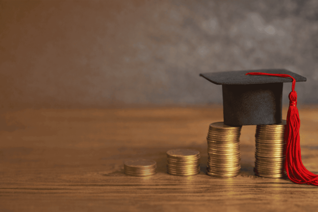 Scholarship and tuition savings concept shown with cap and coins.
